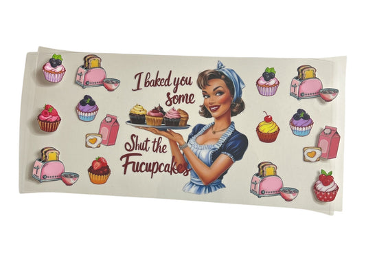 Cup wrap with a retro-style illustration of a woman holding cupcakes and text 'I baked you some cupcakes Shut the Fucupcakes' on a clear background