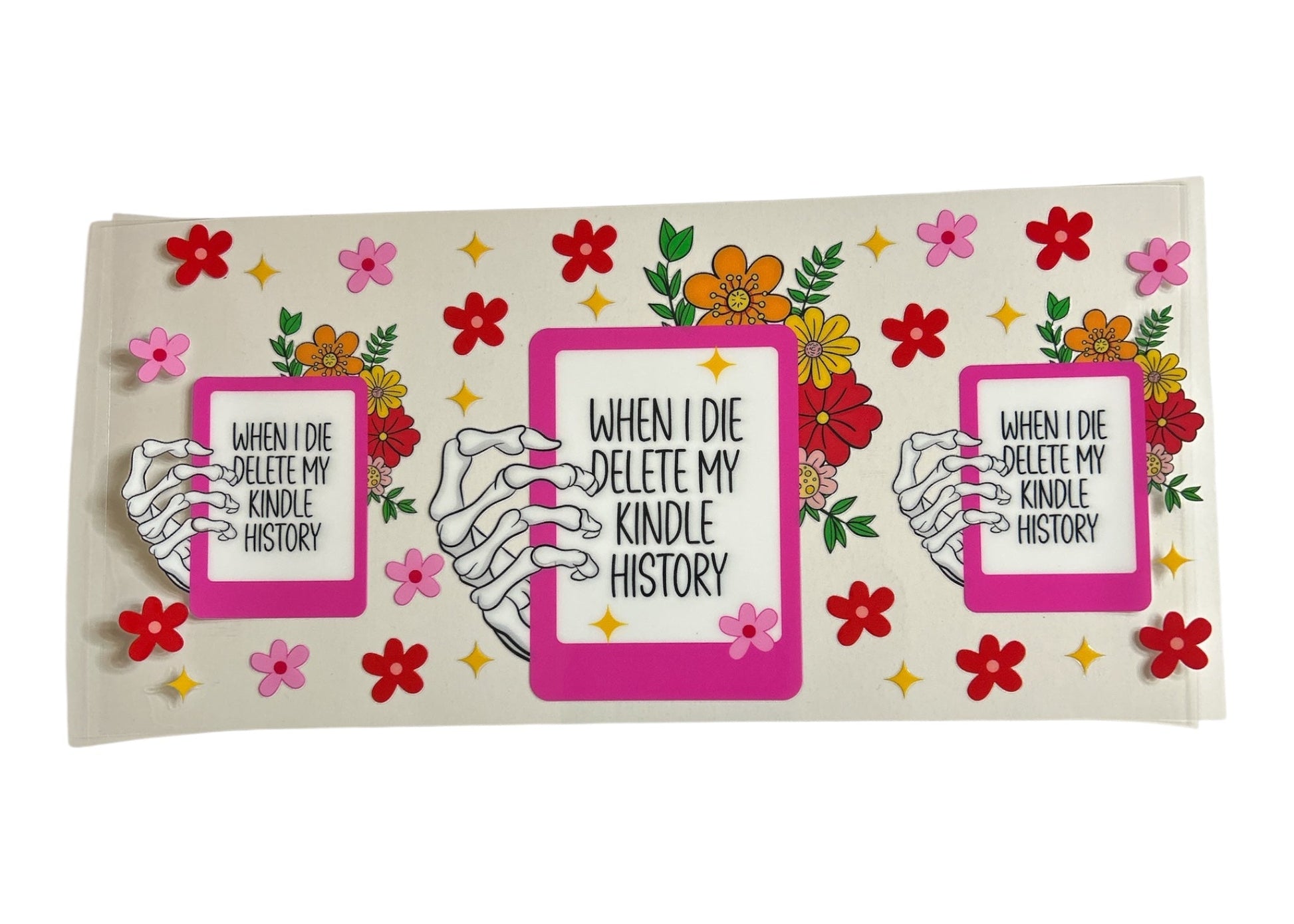 Decorative cup wrap with skeleton hands holding Kindle devices and floral design on a white background
