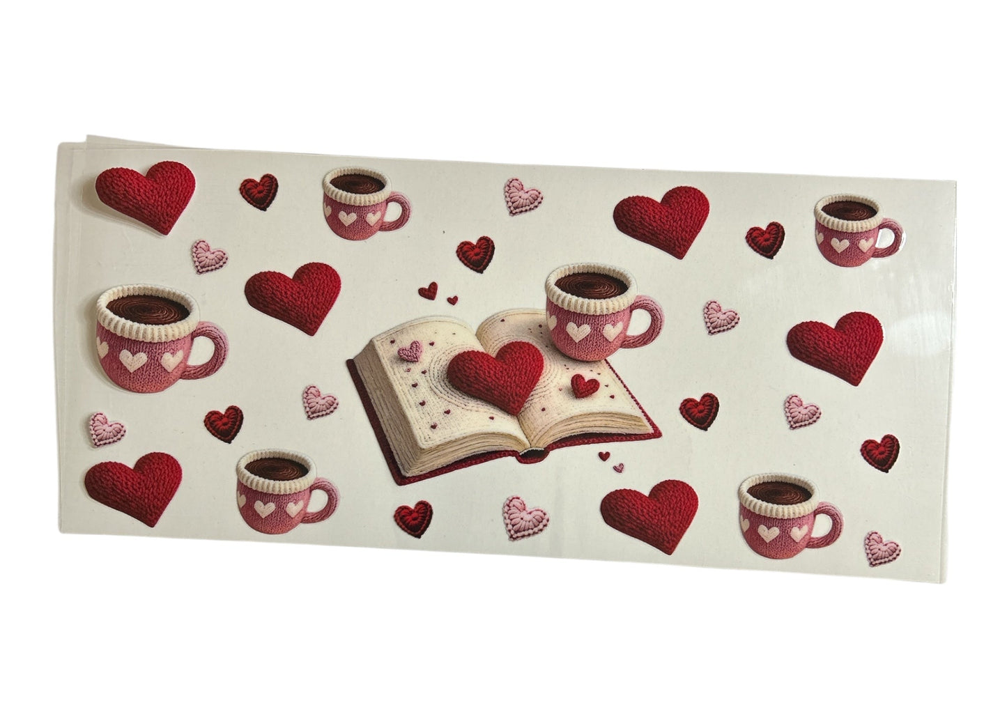 Decorative cup wrap with red hearts, coffee cups, and an open book on a white background