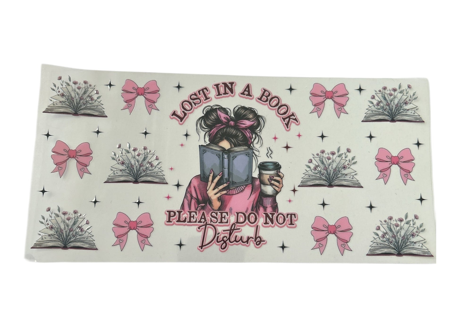 Decorative cup wrap with a person reading a book and text 'Lost in a Book, Please Do Not Disturb' on a clear background.