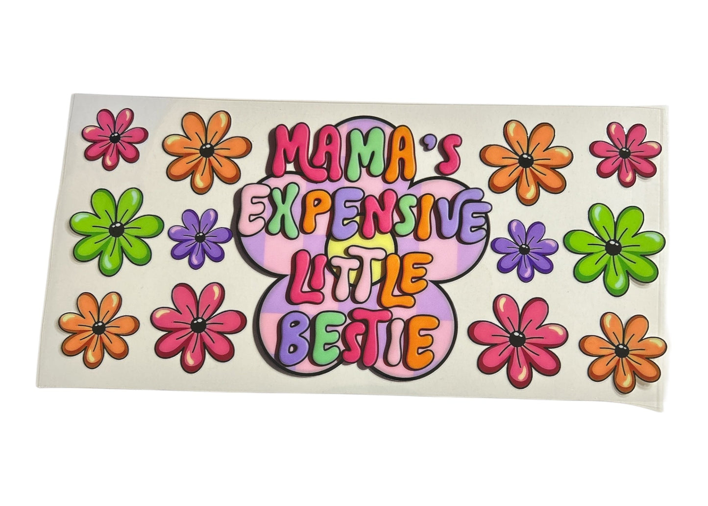 Retro-themed cup wrap with the text "Mama's Expensive Little Bestie" inside a large purple flower, surrounded by colorful orange, pink, green, and purple daisies.