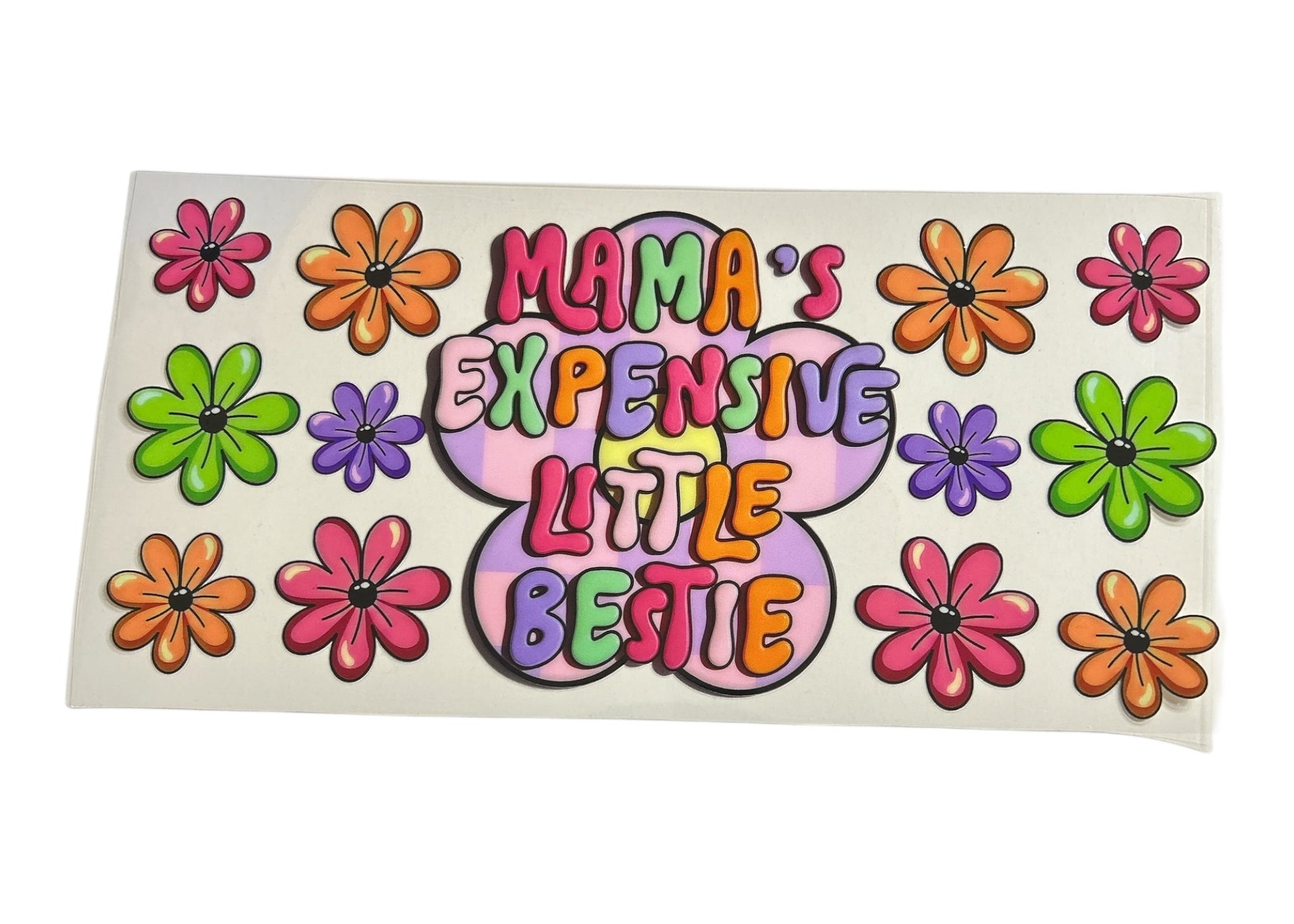 Retro-themed cup wrap with the text "Mama's Expensive Little Bestie" inside a large purple flower, surrounded by colorful orange, pink, green, and purple daisies.