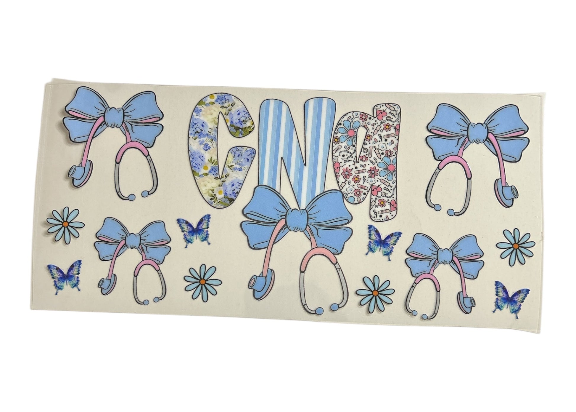 Custom cup wrap featuring the letters "CNA" in three different patterns (floral, striped, and medical doodle icons), surrounded by pink and blue stethoscopes topped with large blue bows, blue daisies, and butterflies.