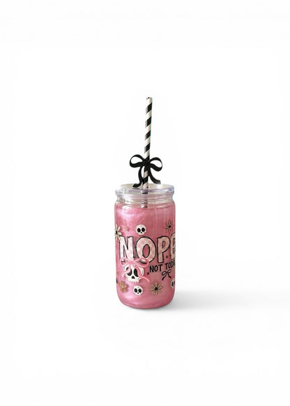 Pink tumbler with straw on a white background